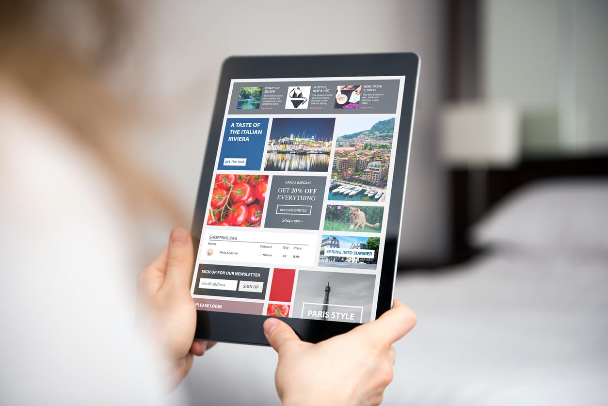 Advertising viewability concept - Woman using a tablet device showing different online advertisements.