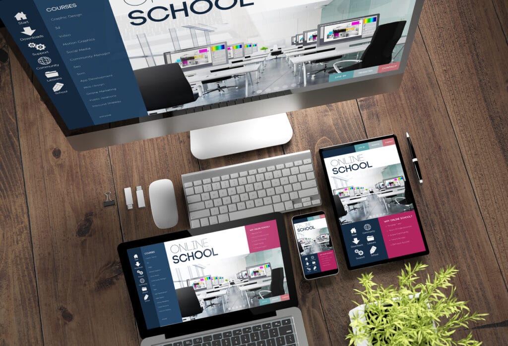 Top view of different devices with website displayed on-screen on wooden desktop
