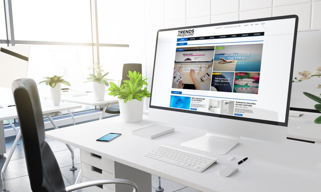 A computer monitor in an office showing a website using Headless WordPress