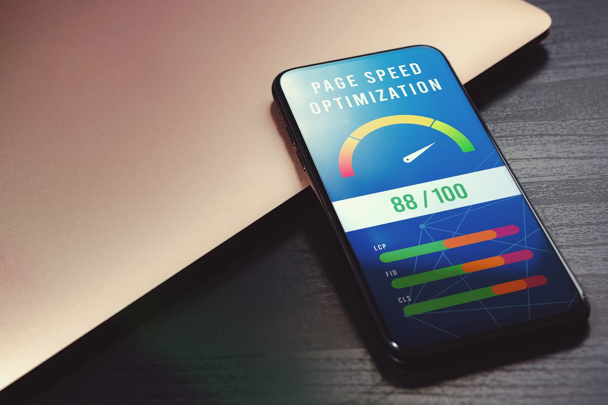 High-value accelerometer on phone screen beside laptop on wooden table for SEO digital marketing visuals.