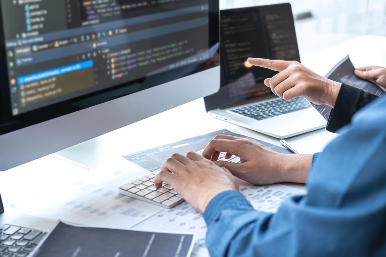 Team of Professional web developers brainstorming while writing programming code.