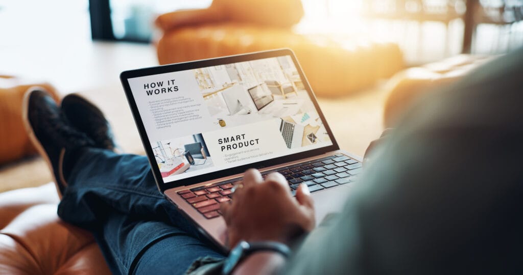 Person on a sofa working on a laptop brand for enterprise website marketing and business branding