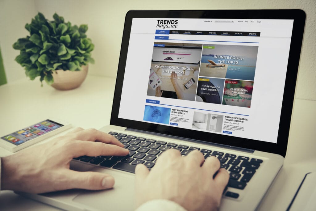 PWA for WordPress: Person's hands on laptop keyboard while navigating a website